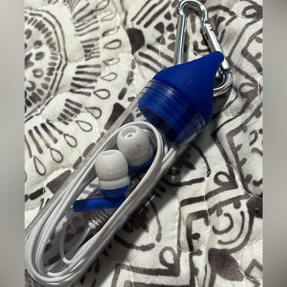 White and blue headphones, never opened, container included